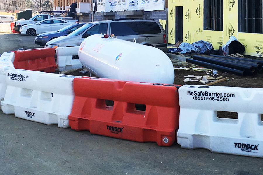 water-flled barriers protect propane tank at construction site