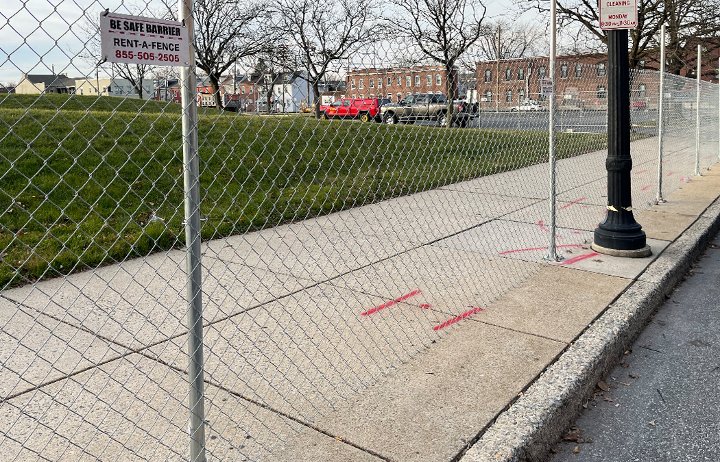 driven fence on sidewalk