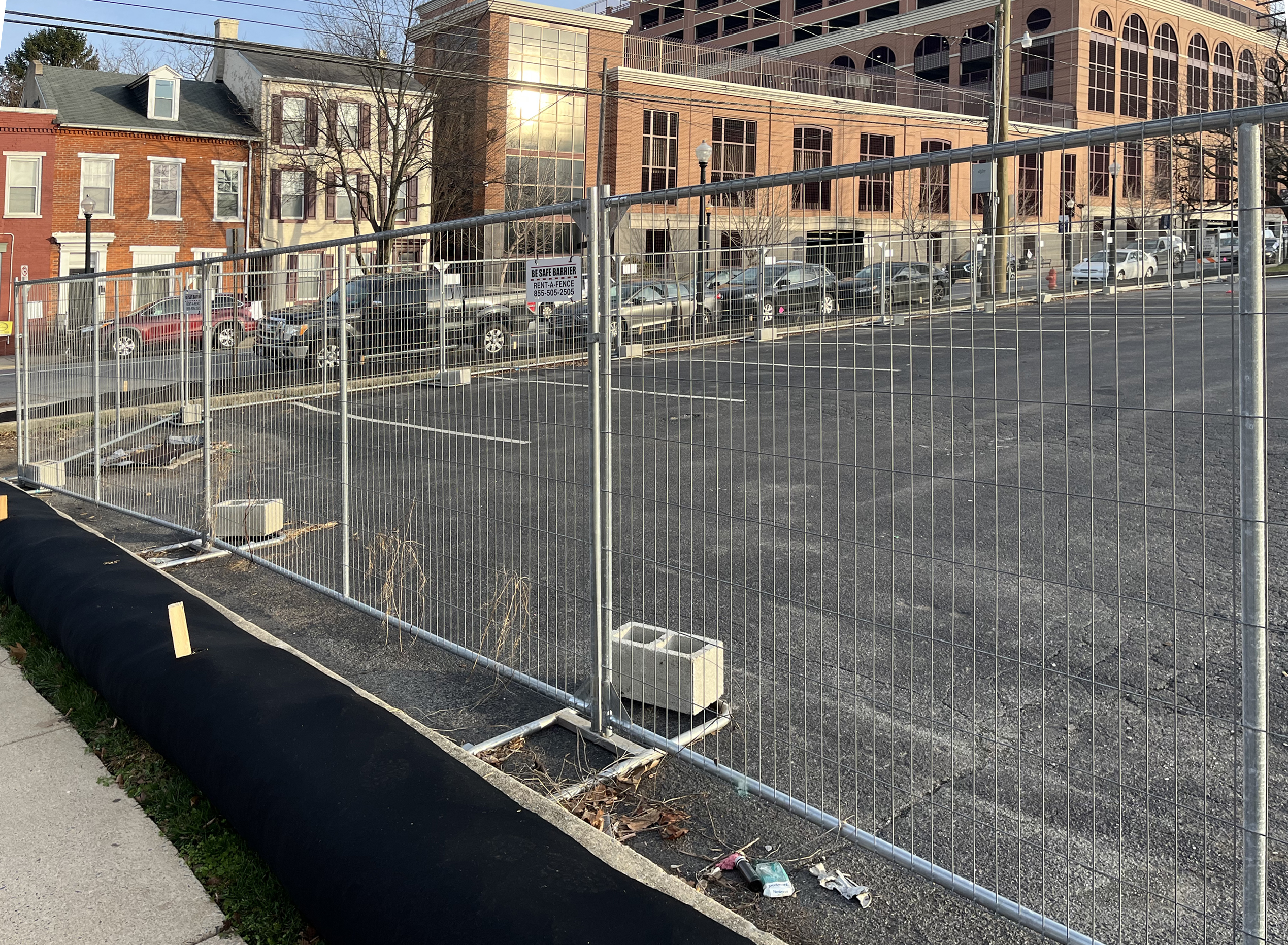 panel fence installed around a parking lot provides protection