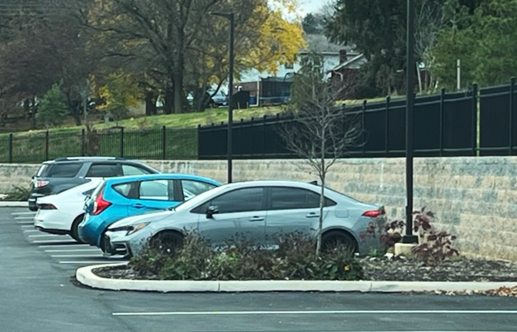 permanent fence encloses parking lot